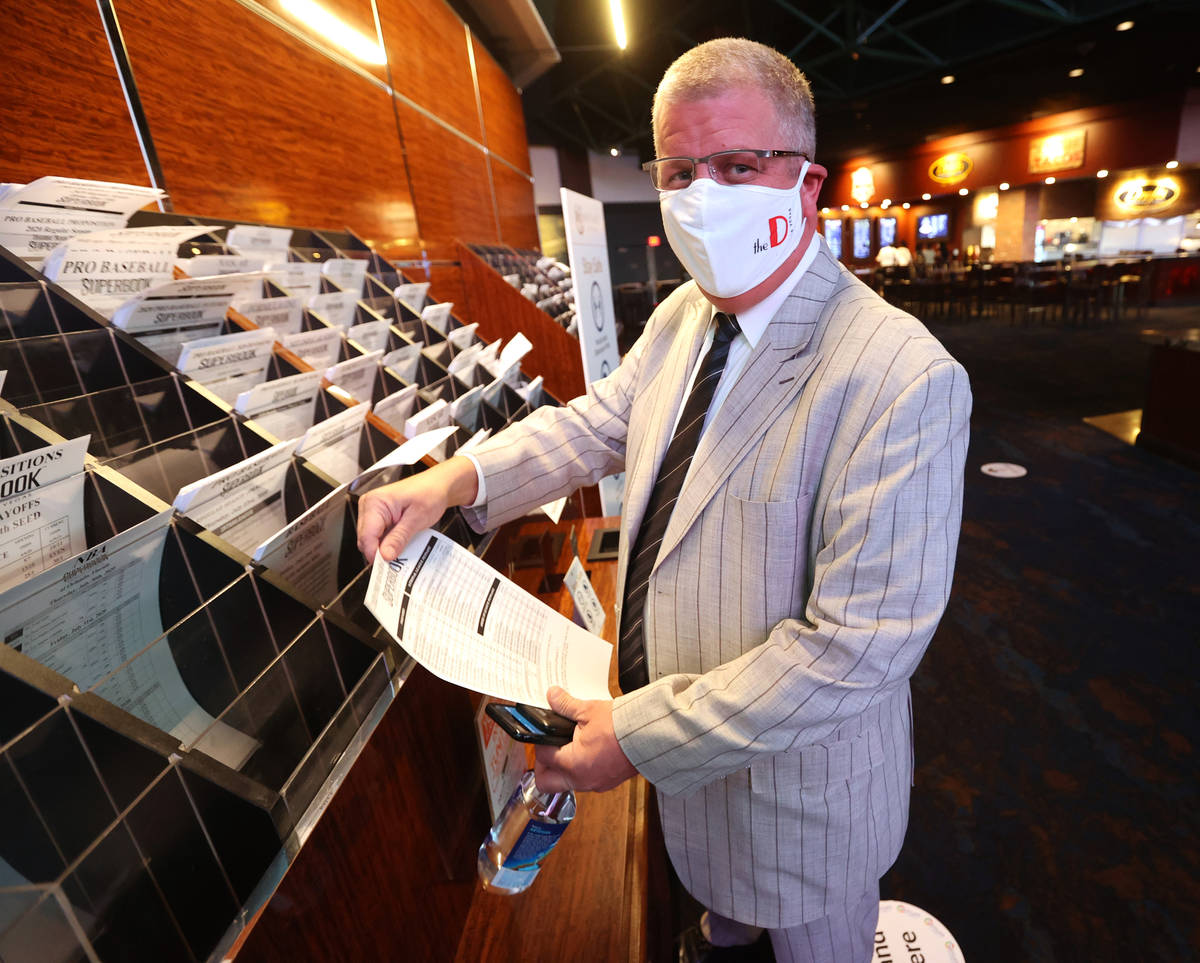 Circa Las Vegas co-owner and CEO Derek Stevens grabs a betting sheet at Westgate sportsbook in ...