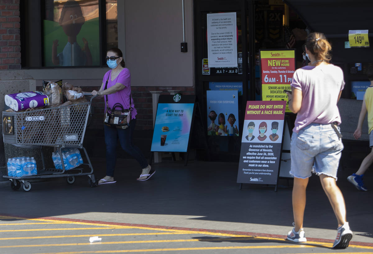 Customers enter and exit the Smith's Food & Drug on West Charleston Boulevard ahead of Inde ...