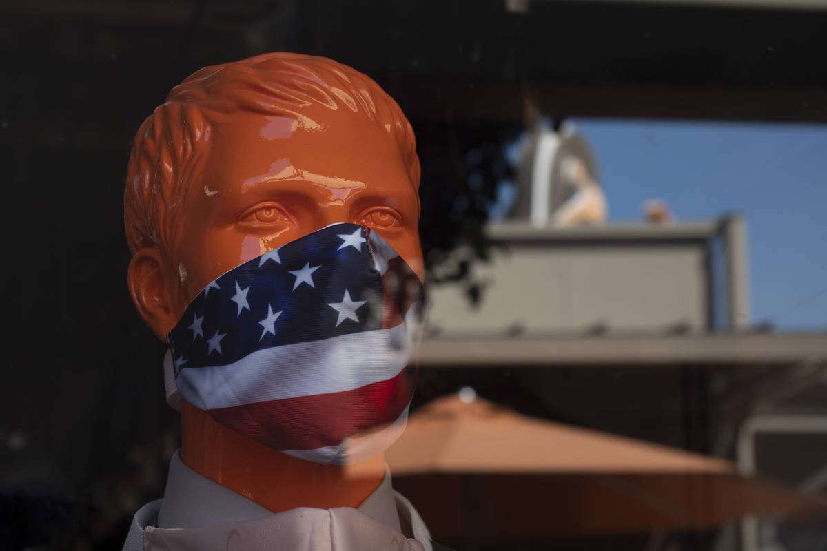 A mannequin wears a face mask at the Citadel Outlets in Commerce, Calif., Thursday, July 2, 202 ...