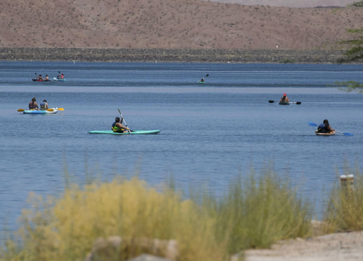 People take advantage of the hot weather to enjoy paddle boarding at Lake Las Vegas on Monday, ...
