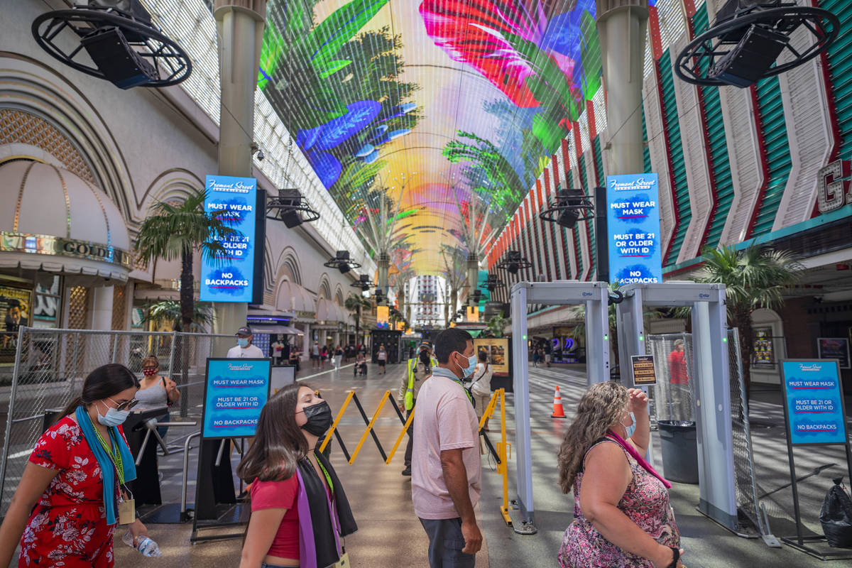 Signs state that masks are required to enter the Fremont Street Experience in downtown Las Vega ...