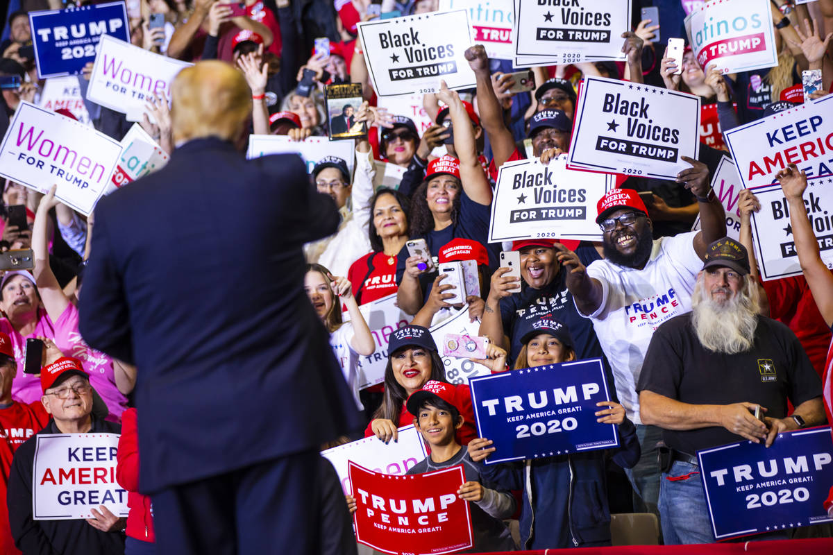 Supporters cheer as President Donald Trump arrives for a rally at the Las Vegas Convention Cent ...