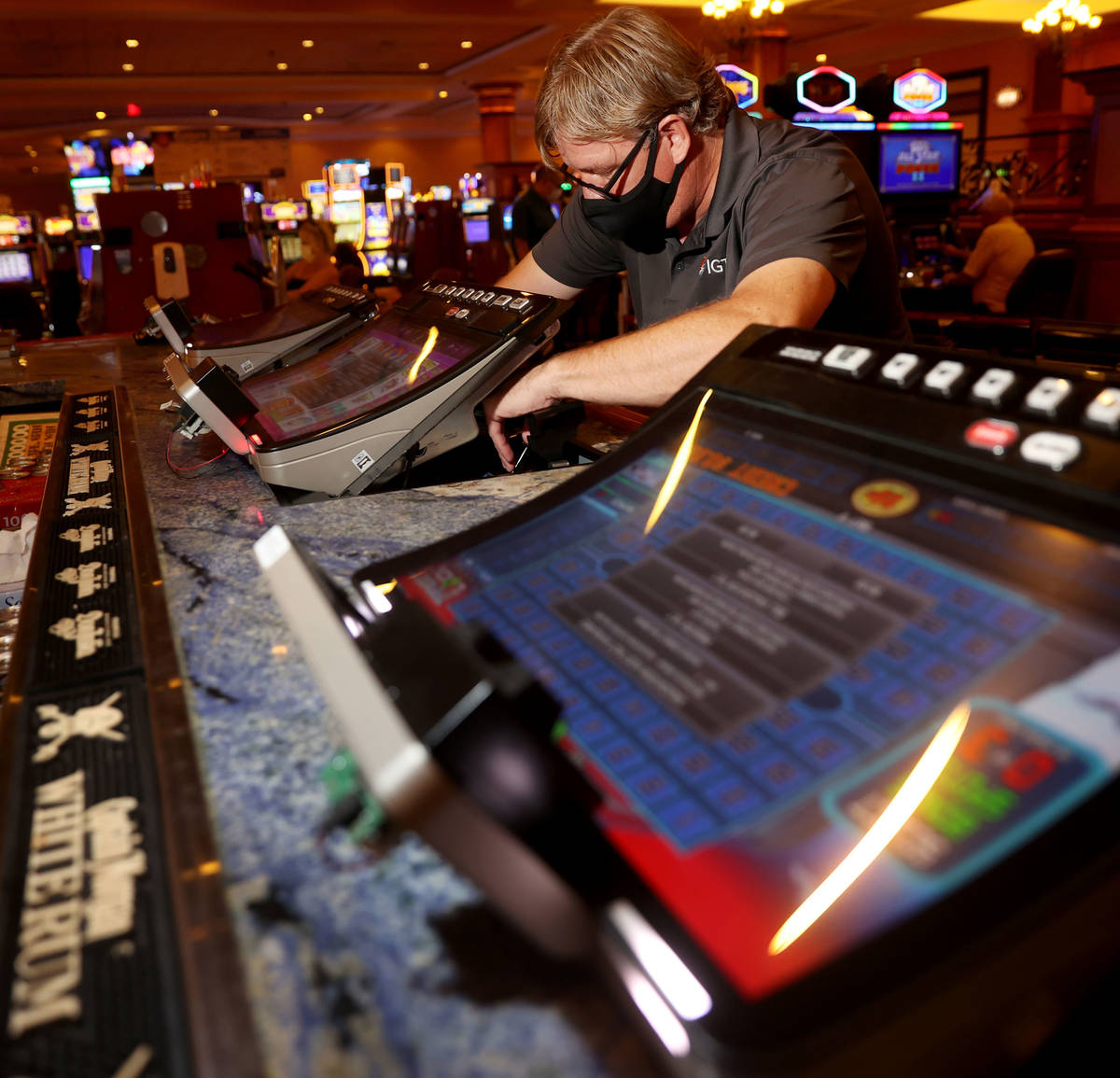 International Game Technology technician Tommy Esposito instalsl PeakBarTop slot machine cabine ...