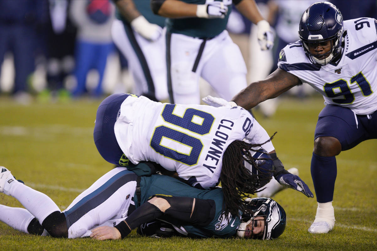 Philadelphia Eagles' Carson Wentz (11) is hit by Seattle Seahawks' Jadeveon Clowney (90) during ...