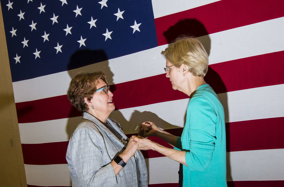 Donna West, chair of the Clark County Democratic Party, left, talks with Democratic presidentia ...