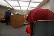 Attorney John Henry Browne, left, stands in view of a video feed as his client Dawit Kelete sit ...