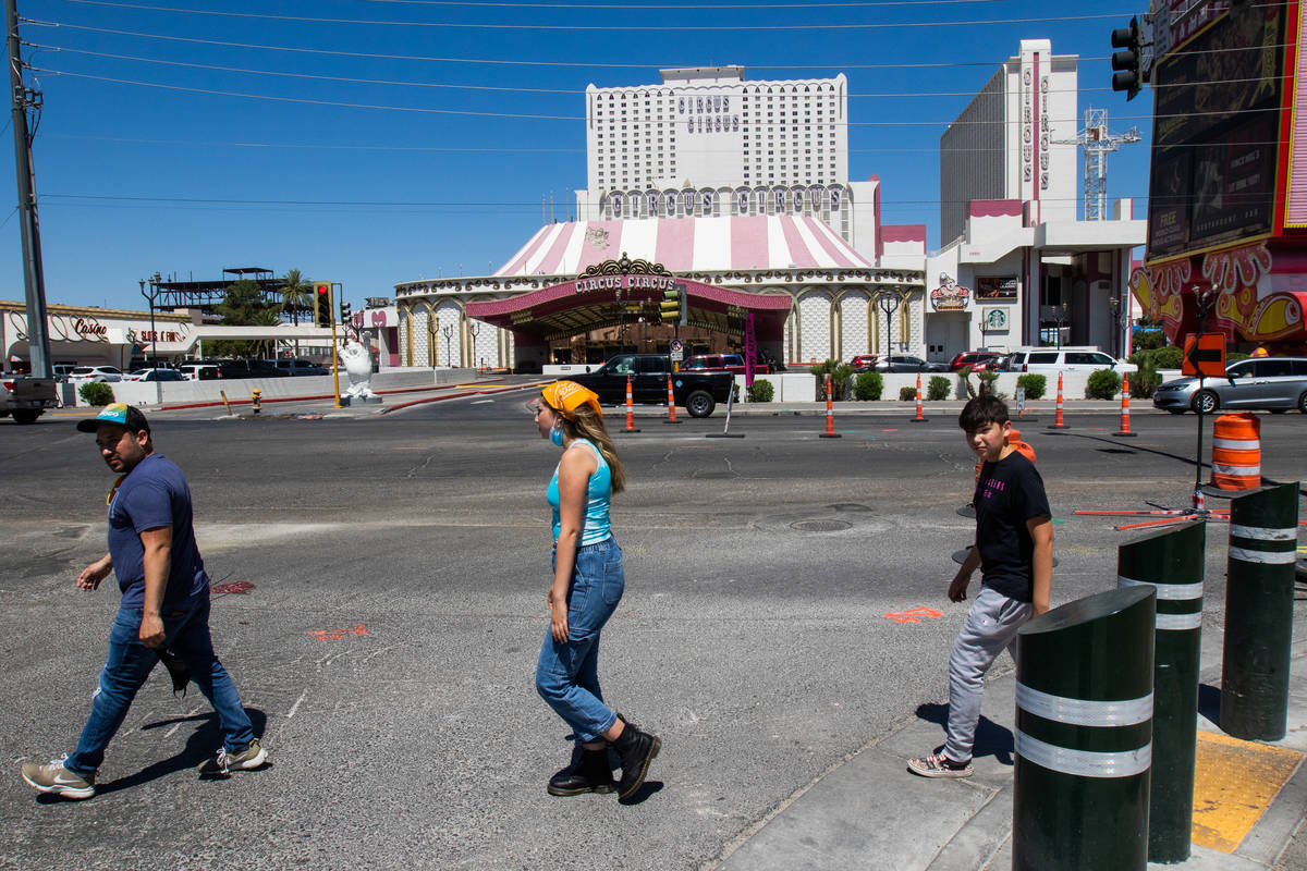 People walk in the crosswalk in front of Circus Circus in Las Vegas on Friday, July 3, 2020. (C ...
