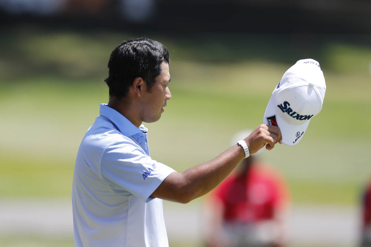 Hideki Matsuyama of Japan talks tips his cap to player partner, Luke Donald on the 18th green d ...