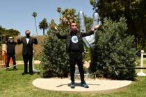 Musician Ringo Starr poses in front of his "Peace and Love" sculpture on his 80th bir ...