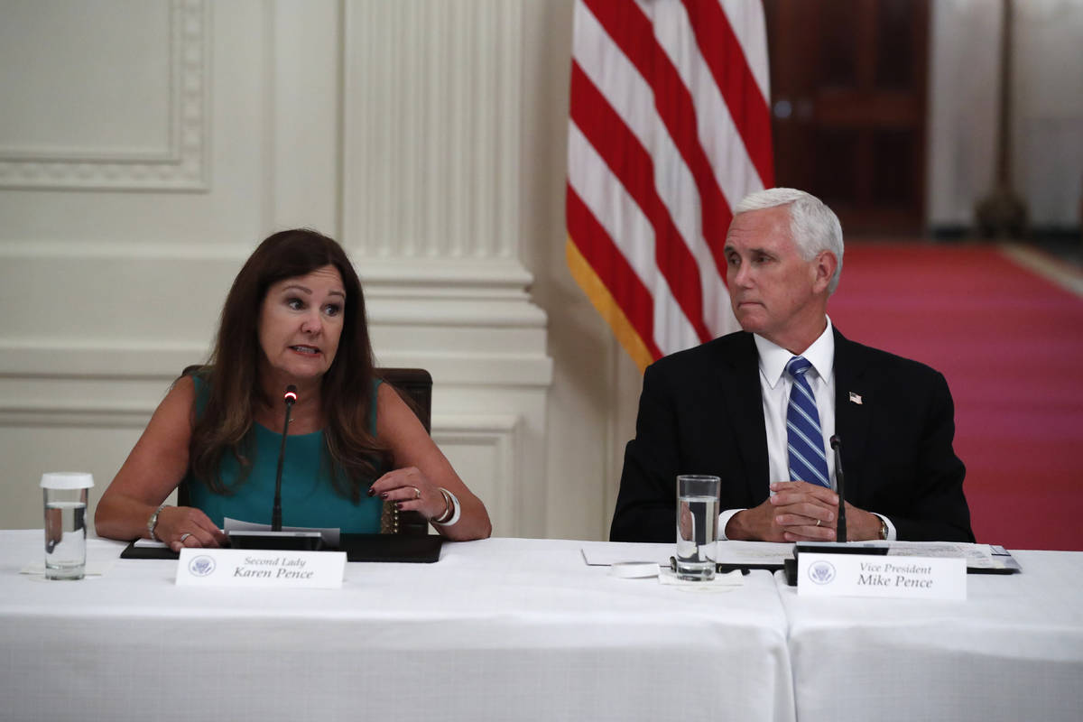 Vice President Mike Pence listens as second lady Karen Pence speaks during a "National Dia ...