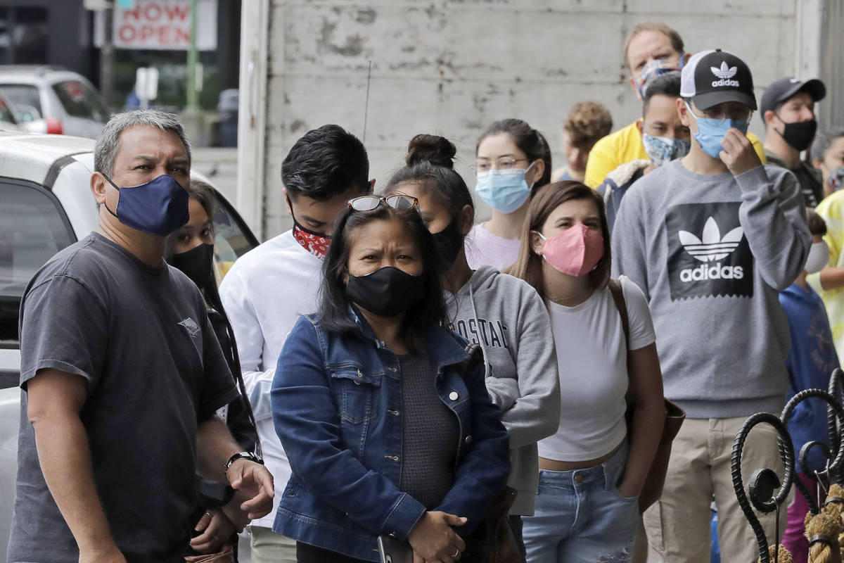 Customers wear masks as they wait to enter the first Starbucks store, which is a popular touris ...