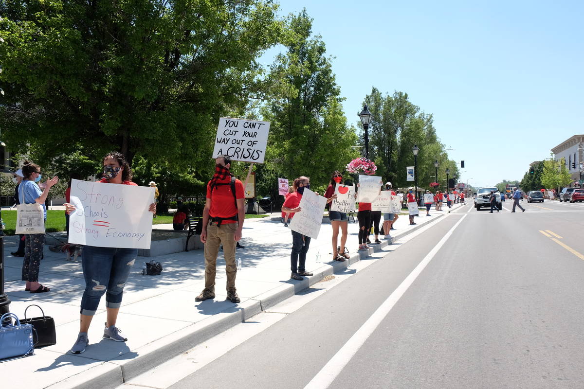 Education advocates protesting possible state budget cuts line Carson Street outside the Nevada ...