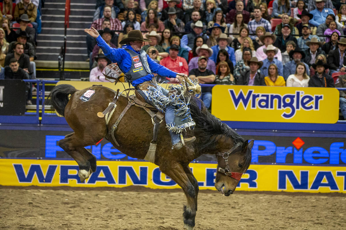 Spencer Wright of Milford, Utah, kicks back for the crowd in Saddle Bronc Riding at the tenth g ...