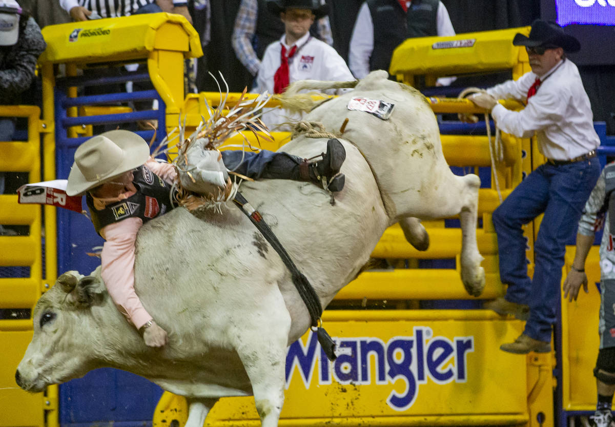 Clayton Sellars of Fruitland Park, Fla., clings to his ride in Bull Riding at the tenth go roun ...