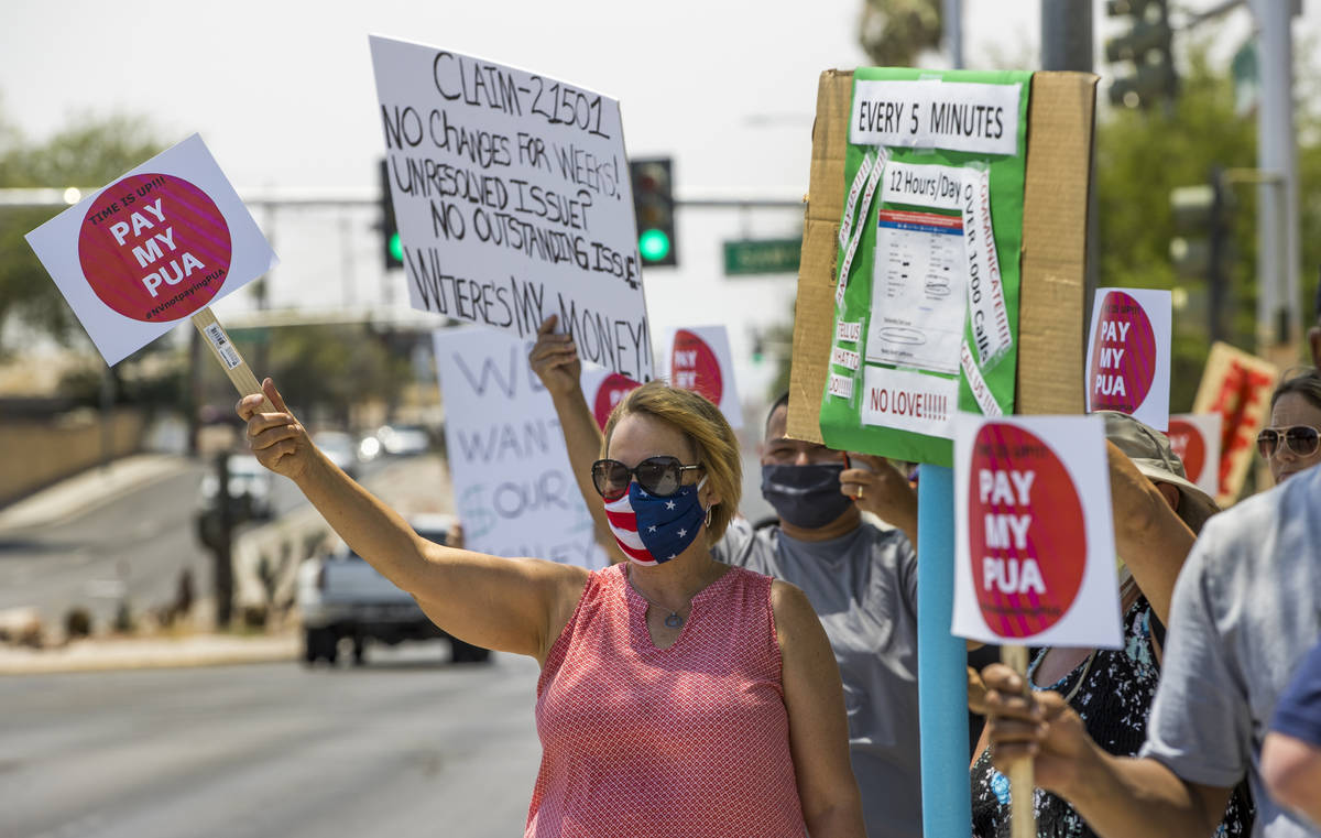 Gig workers gather with signs and wave to passing motorists along East Washington Avenue to pro ...