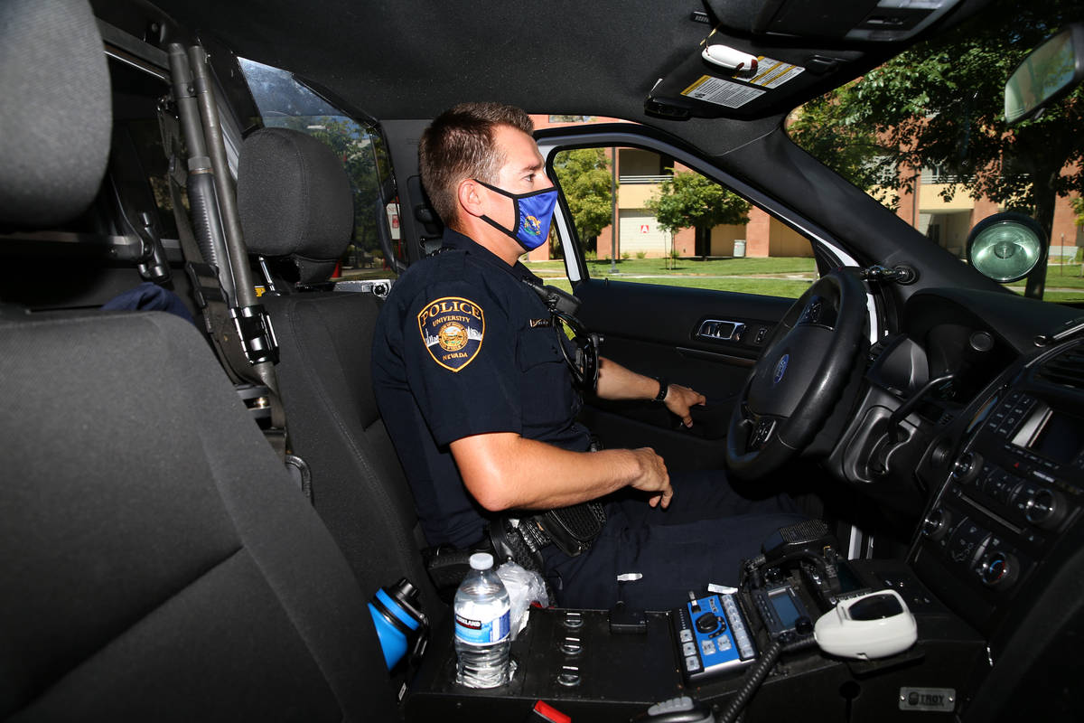 University Police Department officer Ryan Willman returns to his car after a foot patrol at UNL ...