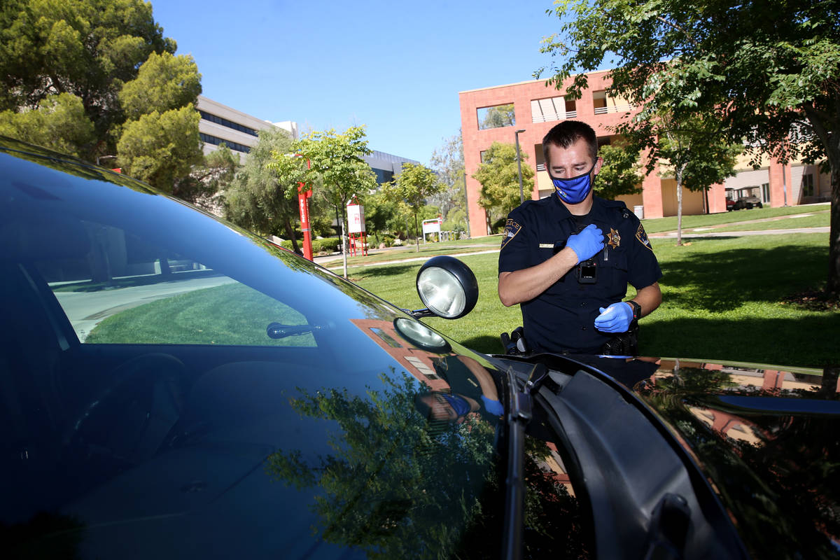 University Police Department officer Ryan Willman returns to his car after a foot patrol at UNL ...