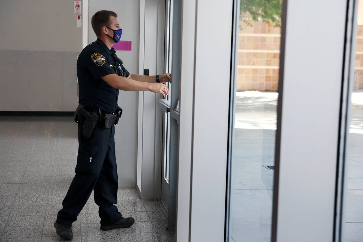 University Police Department officer Ryan Willman checks that the doors are locked at UNLV's St ...