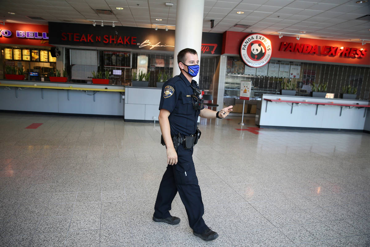 University Police Department officer Ryan Willman patrols the UNLV campus on foot in Las Vegas, ...