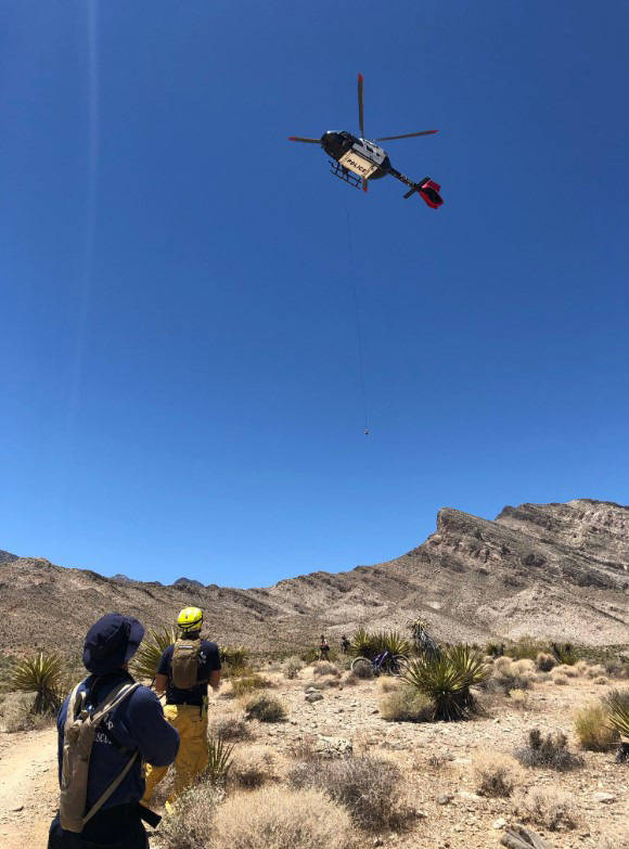 Crews assist an injured dirt bike rider Wednesday, July 8, 2020, near West Lake Mead Boulevard ...