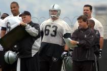 Oakland Raiders center Barret Robbins (63) stands beside coach Bill Callahan, right, during a w ...