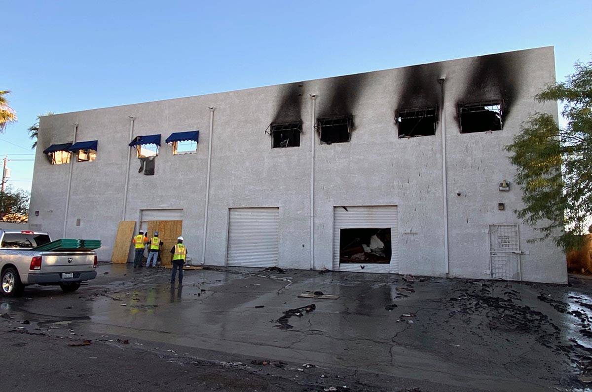 A crew begins to secure the Canyon Electric Company Inc. building after and early morning two-a ...