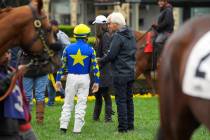 Jockey Drayden Van Dyke, left, talks with trainer Bob Baffert before riding Charlatan in the si ...