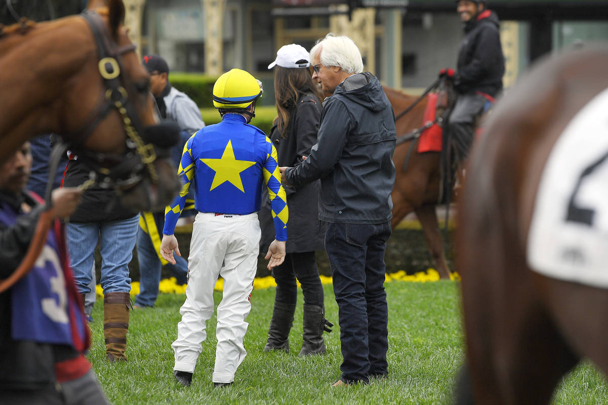 Jockey Drayden Van Dyke, left, talks with trainer Bob Baffert before riding Charlatan in the si ...