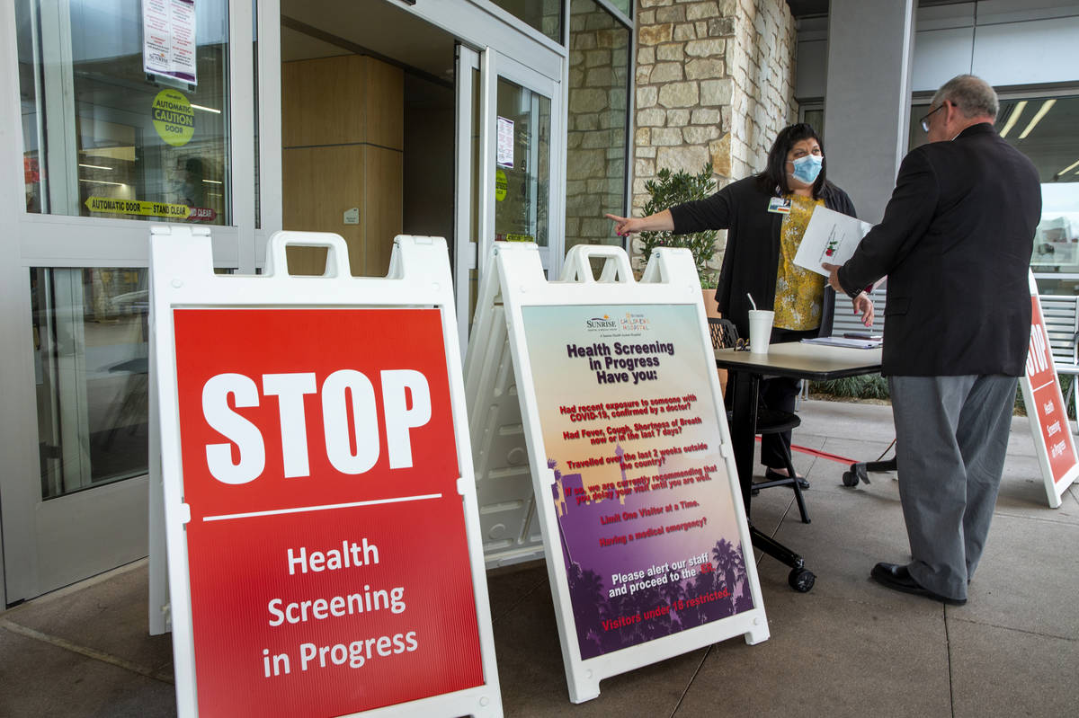 Joey Turken, center, director of Sunrise Hospital's Ethics and Compliance Department, screens a ...