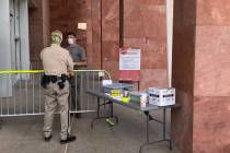 Masked marshals guarded the entrance to the Regional Justice Center, where a mask order has bee ...