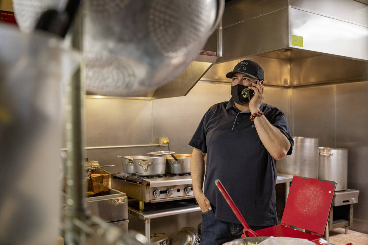 El Menudazo manager Jose Gonzalez takes a phone call in the kitchen of the restaurant in North ...