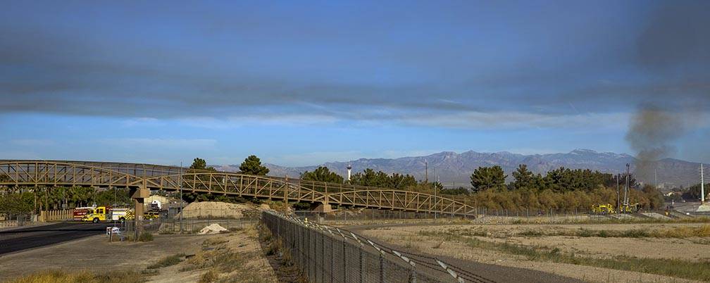 Smoke rises as Clark County firefighters extinguish a brush fire in east Las Vegas near Royal L ...