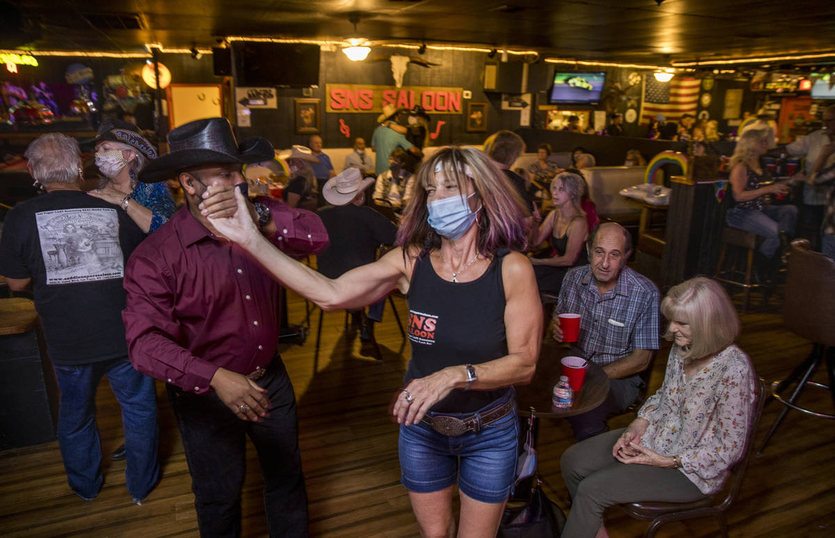 Charles Adams, left, and Debb Saris with Lone Wolf Dancing take to the floor as owner Bobby Kin ...