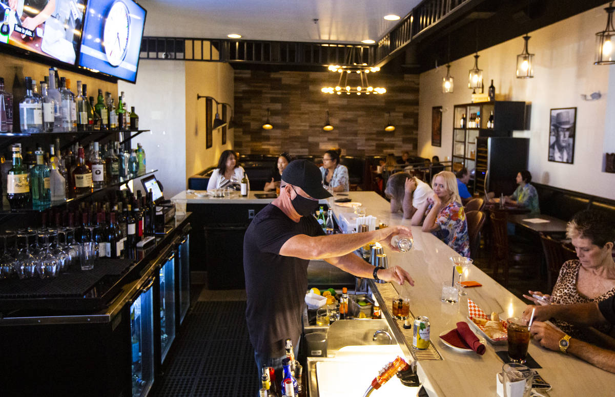 Bar manager David Cooper prepares a drink during happy hour at Spaghetty Western in the Souther ...