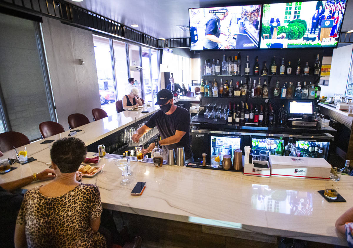 Bar manager David Cooper prepares a drink during happy hour at Spaghetty Western in the Souther ...