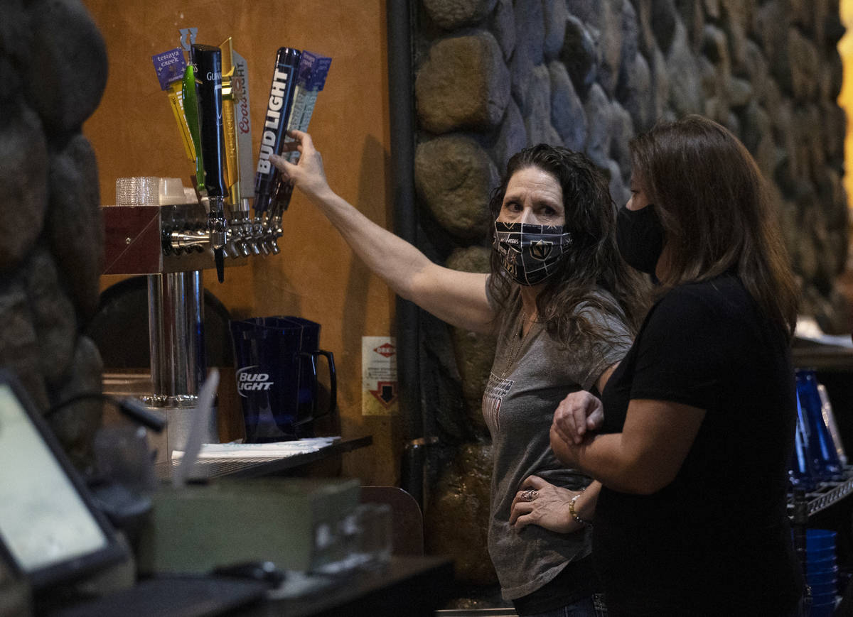Audrey McCartney, left, pours a pitcher of beer at Jackson’s Bar & Grill on Friday, ...