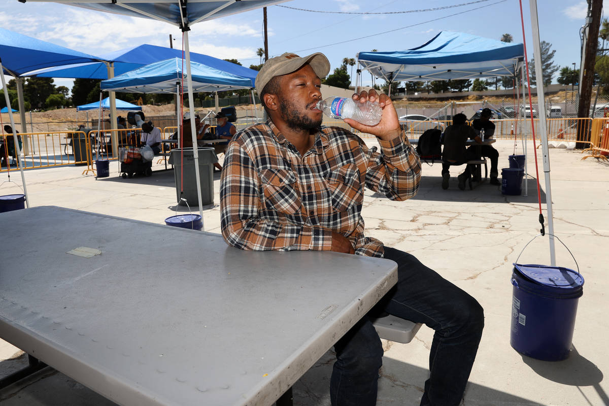 Ronnie Hampton gets a drink of water at the Courtyard Homeless Resource Center cooling station ...
