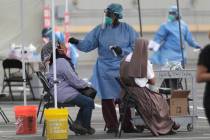 FILE - In this Monday, July 6, 2020 file photo, a health care worker administers a COVID-19 tes ...