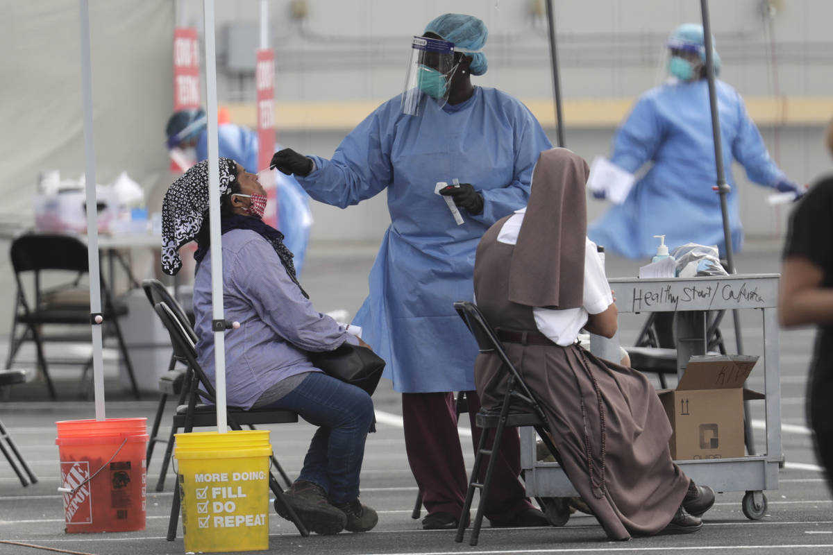 FILE - In this Monday, July 6, 2020 file photo, a health care worker administers a COVID-19 tes ...