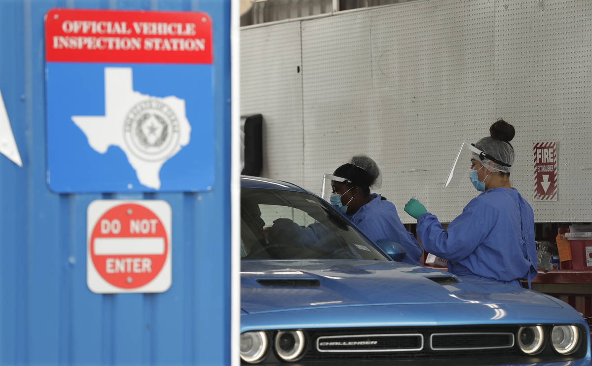 COVID-19 antibody testing and diagnostic testing are administered at a converted vehicle inspec ...