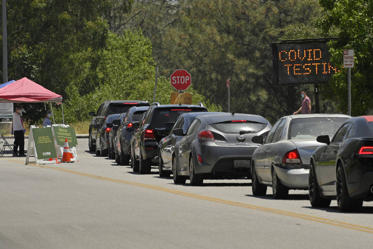 FILE - Cars line up for coronavirus testing at Hansen Dam Recreation Center, Tuesday, July 7, 2 ...