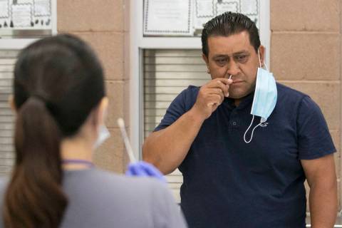Alondra Contreras, left, a register nurse from Southern Nevada Health District, watches as Jose ...