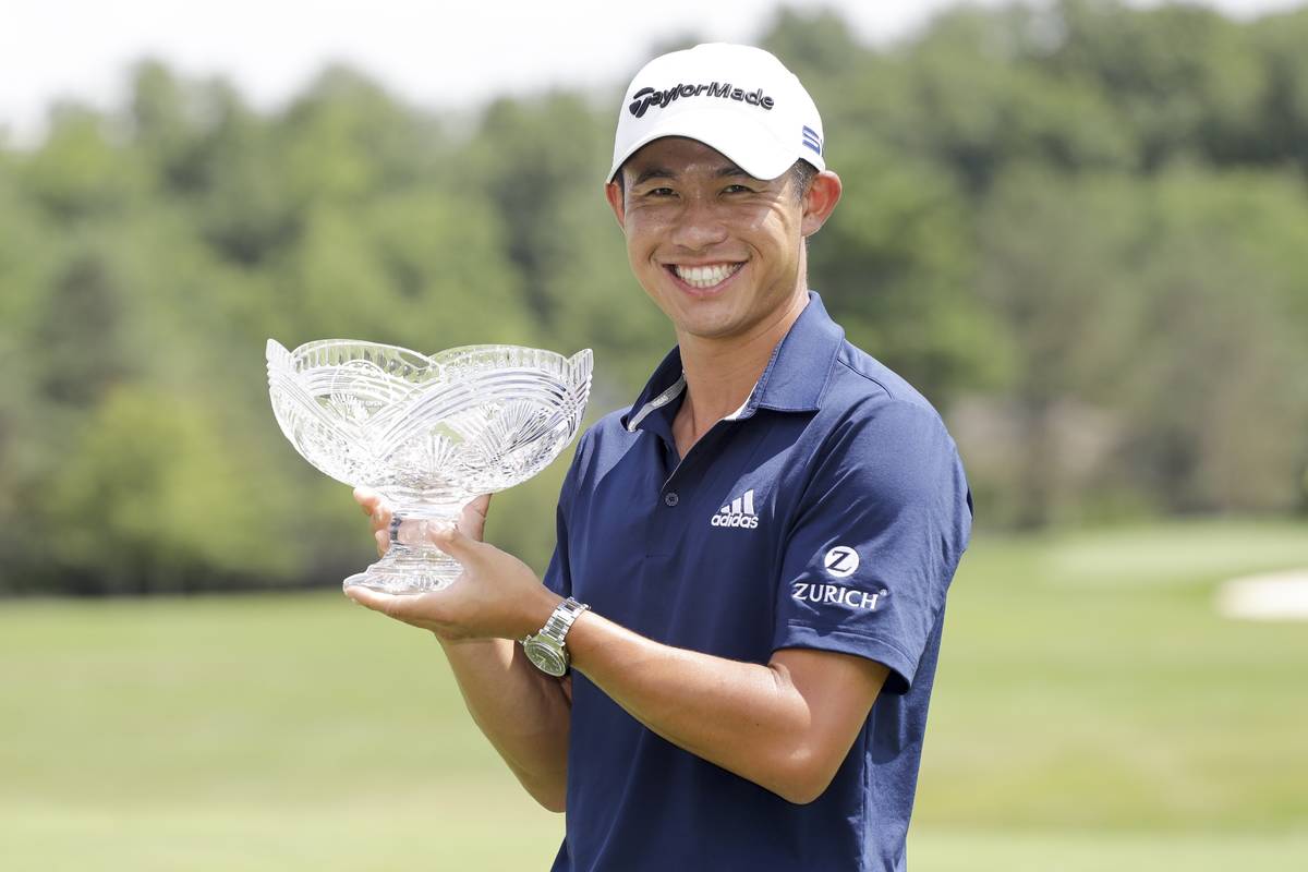 Collin Morikawa holds his trophy after winning the Workday Charity Open golf tournament, Sunday ...