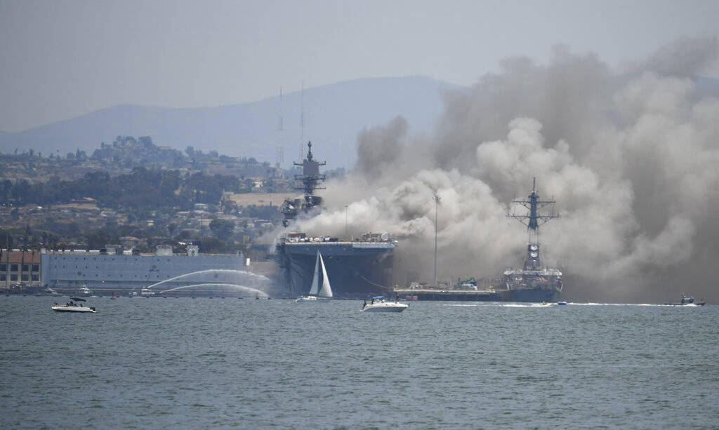 Smoke rises from the USS Bonhomme Richard at Naval Base San Diego Sunday, July 12, 2020, in San ...