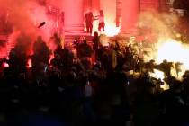 Protesters clash with riot police on the steps of the Serbian parliament during a protest in Be ...