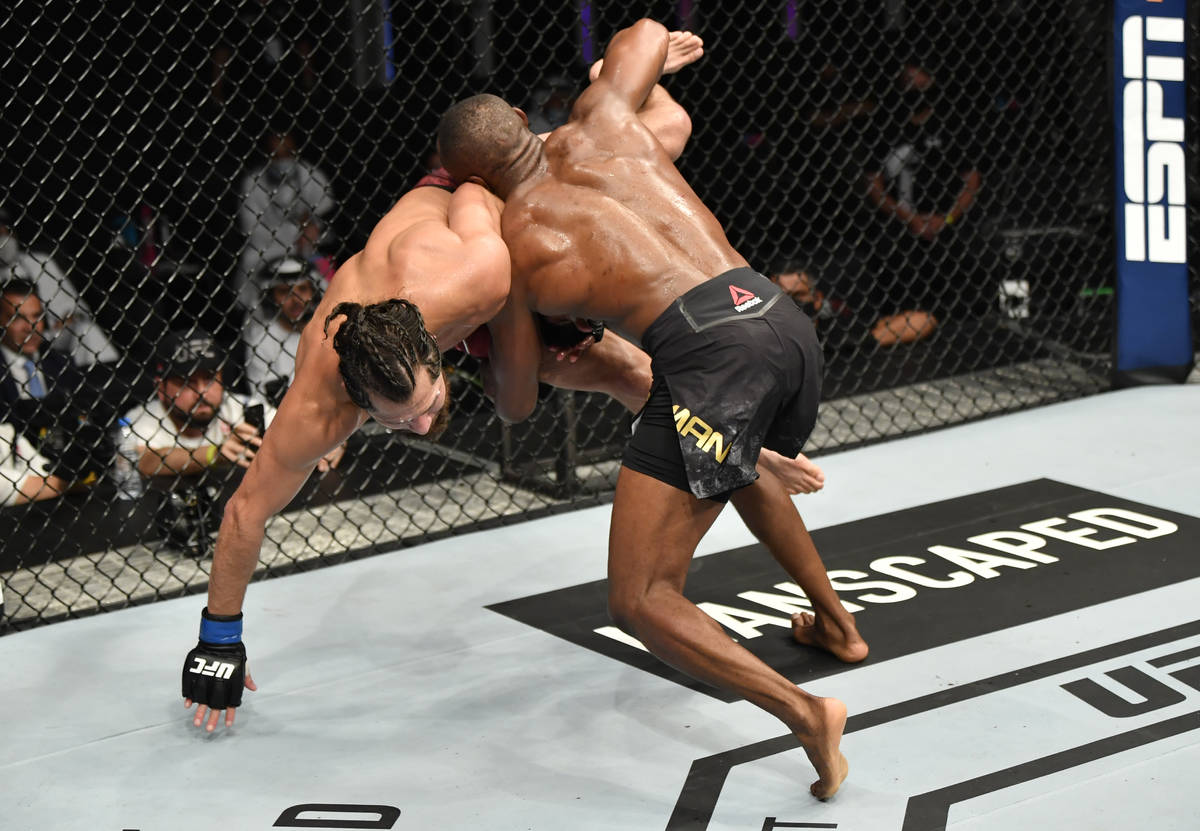 (R-L) Kamaru Usman of Nigeria takes down Jorge Masvidal in their UFC welterweight championship ...