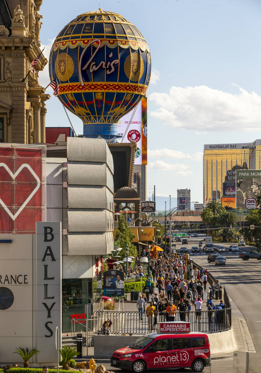 Visitors walk along the Strip near Bally's on Sunday, March 15, 2020 in Las Vegas. (L.E. Baskow ...