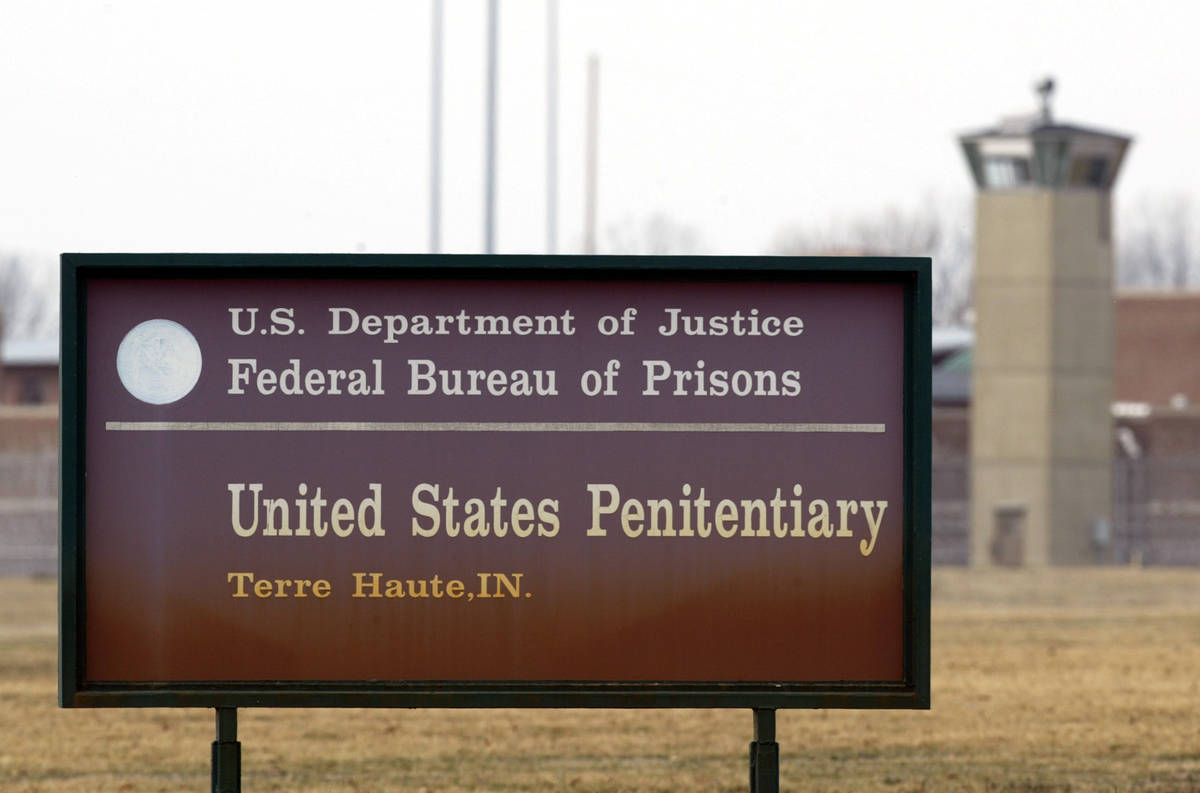 FILE - In this March 17, 2003 oil photo, a guard tower flanks the sign at the entrance to the U ...