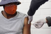In a Wednesday, June 24, 2020, file photo, a volunteer receives a COVID-19 test vaccine injecti ...