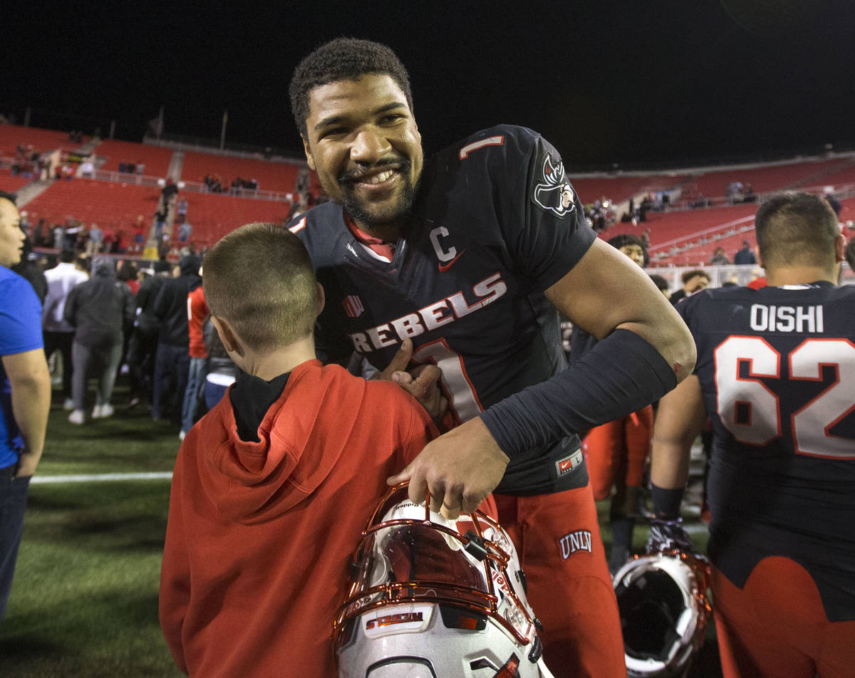UNLV Rebels quarterback Armani Rogers (1) is greeted by fans after defeating UNR Wolf Pack 34-2 ...